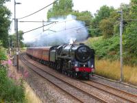 Running south towards Barton and Broughton on the WCML on 15 August 2011, Britannia Pacific no 70013 <I>Oliver Cromwell</I> makes easy work of <I>The Mersey Moorlander</I> with its 12 coach load. <br><br>[John McIntyre 15/08/2011]