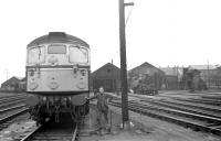 A fireman poses for the camera beside a BRCW Type 2 on the Down side of St Margarets shed on a Summer day in 1966. A 2-6-4 tank is simmering in the background and a diesel shunter can just be seen on the Up side, beyond the running lines of the ECML.<br>
<br><br>[David Spaven //1966]