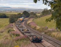 DRS 66424 heads a train of flats towards Grangemouth, just north of Greenfoot on 29 August 2011.<br>
<br><br>[Bill Roberton 29/08/2011]
