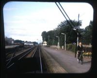 <I>On yer bike!</I> The old order at Nairn in the summer of 1973, as the signalman pedals from the west box back to the token instruments in the station building. Taken from the rear of an Inverness-Aberdeen DMU.<br>
<br><br>[David Spaven //1973]
