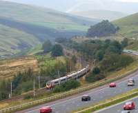 A northbound Pendolino speeds through the Lune Valley towards Tebay on 10 September, passing traffic on the M6 motorway.<br><br>[John McIntyre 10/09/2011]