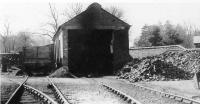 The hospital railway engine shed at Whittingham, pictured some time in the 1950s. The resident locomotives are not to be seen in this view but a wooden bodied coal wagon stands alongside. After the 1957 line closure the shed lived on and is still in use in 2011 as an NHS workshop. [See image 35695]. <br><br>[David Hindle Collection //]