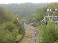 A wealth of home signals covering the loop section of the Margam line beyond Tondu station junction as seen from the station footbridge in September 2011. The former Margam bound platform face can still be seen on the left. This line has seen extensive week-end freight use over winter 2011-12 to allow steel services to bypass track works taking place between Margam and Bridgend <br><br>[David Pesterfield 14/09/2011]
