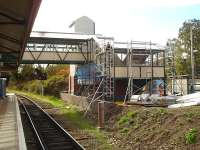 Footbridge/access improvements in progress at Wrexham General station on 12 October 2011, view south along platform 3 with a platform 4 waiting shelter visible to right of the new steps structure [see image 35162].<br><br>[David Pesterfield 12/10/2011]