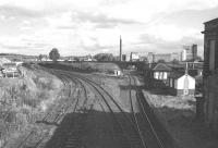The east end of the old Alloa station, seen here in 1975, approximately 7 years after closure to passengers. The Devon Valley route, closed completely in 1973, runs off to the left and Alloa East signal box is now boarded up. On the other side of the old Waggonway Bridge stands the now demolished brewery, the site of which is today occupied by the new (2008) Alloa station and the Asda Superstore. [See image 18651] <br><br>[Bill Roberton //1975]
