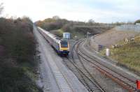 Looking west from the road bridge adjacent to the branch into the Keypoint Railfreight terminal/interchange on the east side of Swindon as a First Great Western HST passes by en route to Paddington. <br><br>[Peter Todd 06/12/2011]