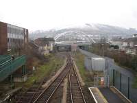 Looking towards Treherbert from Porth station on 31 January 2012. On the left is the former down track, now a long siding. The route is now single track forward to Treherbert, apart from the passing loop at Ystrad Rhondda. Token operation applies from Porth to Ystrad Rhondda and from there to Treherbert. The path running forward to the right of the railway is on the trackbed of the former Maerdy branch which ran under the right hand side of the road overbridge.<br><br>[David Pesterfield 31/01/2012]
