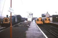 Station scene at Sandown, Isle of Wight, in February 1988. On the right are two of the local trains based on ex-London Transport tube stock, while on the left BR Class 03 0-6-0 DM no 03079 stands with permanent way vehicles. The locomotive, which also carried the numbers D2079 and 97805 during its lifetime, is now preserved on the Derwent Valley Light Railway.<br><br>[Ian Dinmore /02/1988]