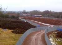 Work continues on the North Chord embankment at Nuneaton on 12 February 2012 as an up Pendolino storms past on the WCML in the background. [See image 36137]<br><br>[Ken Strachan 12/02/2012]