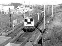 A southbound permanent way train runs through Carstairs on 17 April 1980 behind 20137+20124. The train is about to pass Strawfrank (now Carstairs South) Junction with the direct Edinburgh line branching off to the right.<br><br>[John Furnevel 17/04/1980]