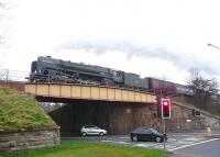 'The Auld Reekie' charter, hauled by Britannia Pacific no 70013 <I>Oliver Cromwell</I> westbound on the Edinburgh 'sub' on 24 March 2012 on its way back to Manchester Victoria. The train is seen here crossing Lady Road at Cameron Toll on Edinburgh's southside.<br><br>[Jim Peebles 24/03/2012]