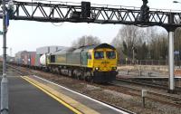 Freightliner 66594 with eastbound containers through Swindon station on 22 March 2012.<br><br>[Peter Todd 22/03/2012]
