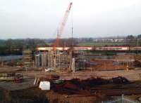 The setting sun lights up a down Pendolino on 2 March 2012 as it passes ongoing work on the accommodation bridge at Stoney Road that will form part of the Nuneaton North Chord.<br><br>[Ken Strachan 02/03/2012]