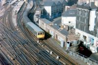 A North Tyneside DMU leaving one of the east end bay platforms at Newcastle Central (now part of a car park) in March 1980. Notable in the picture is the old North Eastern Railway 1906 parcels depot in Westgate Road (with the triple pitched roof). [See image 9463]<br><br>[Colin Alexander 08/03/1980]