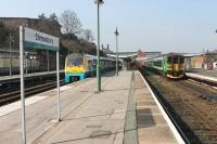The striking London Midland livery of a 153/170 combination in Shrewsbury's bay platform contrasts with the Arriva Trains Wales blue of 175103. The LM units had arrived from Birmingham via Telford on 24 April and behind them was the 153 that had worked in from Swansea via the Central Wales line.  <br><br>[Mark Bartlett 24/03/2012]