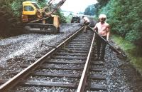 Track lifting in progress on the Waverley Route between Scotch Dyke and Longtown, thought to have been taken in 1971 - the A7 can just be seen in the background above the tractor.<br>
<br>
<br>
<br><br>[Bruce McCartney Collection //1971]