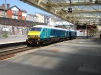Arriva Trains Wales liveried 67003 heads a matching liveried DVT east through platform 4 at Newport on 22 May 2012.<br><br>[David Pesterfield 22/05/2012]