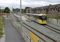 <I>Temporary terminus - future junction</I>. St Werburgh's Rd in Chorlton is a new tram stop on the Metrolink line line to East Didsbury. The line opened fully in 2013 but in 2012 this was the temporary limit of operations. 2014 also saw a new line to Manchester Airport join the system and this diverges at this station. Tram 3018 has just reversed and leaves for Oldham Mumps.<br><br>[Mark Bartlett 17/08/2012]