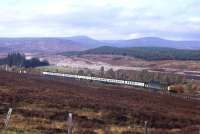 Tougher competition from the new A9 is evident as this Class 40-hauled Highland Main Line train approaches Dalanraoch in 1977.<br><br>[Frank Spaven Collection (Courtesy David Spaven) //1977]