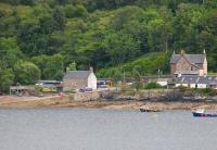 Stromeferry station, as seen across tidal Loch Carron, from Strome Castle on the north bank. 158705 has just called on its way to Inverness with the 1715hrs from Kyle. In front of the station is the slipway of the old car ferry, replaced by the A-road from Strathcarron in the 1960s. <br><br>[Mark Bartlett 10/07/2012]