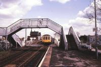 A Cleethorpes - Sheffield DMU about to run over the level crossing and into the up platform at Habrough, Lincolnshire, on the western outskirts of Immingham, in May 1986.<br><br>[Ian Dinmore /05/1986]