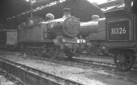 Wet day at Nine Elms. Locomotives in the shed yard at 70A on 21 August 1961 include E2 0-6-0T no 32102, with the rear end of H class 0-4-4T no 31326 nearest the camera. Both locomotives were withdrawn by BR in October that year.<br><br>[K A Gray 21/08/1961]