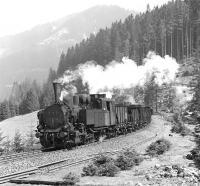 Giesl ejector fitted 0-6-2RT No. 97.208 eases the 09.39 empties from Vordernberg downhill at Feistawiese on 14 April 1976, with sister locomotive No. 97.201 providing additional braking assistance at the rear of the train.<br><br>[Bill Jamieson 14/04/1976]