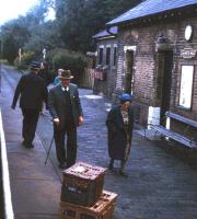A long forgotten aspect of the railway 'parcels' business - baskets of live homing pigeons on the platform at Lllanwrtyd Wells station on the Central Wales Line in summer 1971. Pigeon fanciers would send the baskets by train, with a 50p coin attached as a tip to rail platform staff for setting the pigeons free!<br><br>[David Spaven //1971]