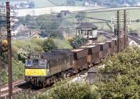 The use of a loco of only 1250 HP on the Tunstead to Winnington limestone trains might seem rather surprising, nonetheless the BR Type 2s still managed a twenty year sojourn on these duties. D7659 passes Chinley North Junction with returning empties on the sunny morning of July 17th 1972.<br><br>[Bill Jamieson 17/07/1972]