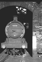 J27 0-6-0 no 65870 stands in the arched entrance to the roundhouse at Sunderland South Dock, thought to be in the autumn of 1962.<br><br>[K A Gray //1962]
