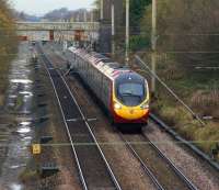 An up 9-car Pendolino climbs towards the summit between Preston and Wigan at Coppull on 23 November 2012. Coppull station was situated approximately a quarter of a mile to the north.<br><br>[John McIntyre 23/11/2012]