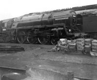 BR Britannia Pacific no 70004 <I>William Shakespeare</I> stabled alongside a stack of firebox arch blocks in Crewe North shed yard in April 1964.<br><br>[David Pesterfield 18/04/1964]