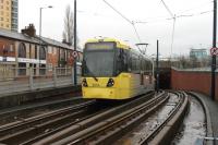 There are several parts of the Manchester Metrolink system that take advantage of climbing abilities of modern trams compared with heavy rail traction. Immediately after leaving the Eccles terminus the tracks dive under a large roundabout and climb back for street level running on the other side. 3014 enters the underpass on 28 December 2012 while operating an Eccles to Piccadilly service.  <br><br>[Mark Bartlett 28/12/2012]