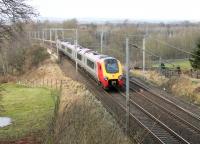 A Super Voyager heads north along the WCML towards Penrith. The train has just passed under the A6 road in Clifton village and is now crossing the M6 Motorway. The long closed station was some distance south of the village.<br><br>[Mark Bartlett 04/02/2013]