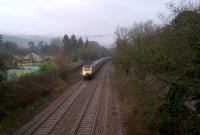A London-bound HST accelerates away wrong line from a signal stop at Bathampton Junction on 9 February. Despite the adjacent road traffic, the HST exhaust could be heard all the way from the stop, 2.5 miles away! The line of hills in the background appears to be that which separates the Bath-Southampton line from the trackbed of the late-lamented Somerset and Dorset Railway.<br><br>[Ken Strachan 09/02/2013]