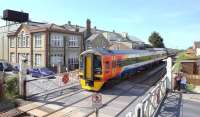 An East Midlands Trains 158 on Attleborough level crossing, Norfolk, in May 2011 with a Norwich - Liverpool Lime Street service. View is south west towards Ely.<br><br>[Ian Dinmore /05/2011]