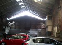 Brunel's original train shed at Temple Meads in February 2013. The site is now used for car parking (with a �1 discount for parking outdoors!), but should soon be reopened as a terminus for electric trains from London. Notice the signal box on the right.<br><br>[Ken Strachan 10/02/2013]
