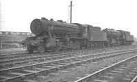 A pair of WD <I>Austerity</I> 2-8-0s on Wakefield shed on a grey March morning in 1961. Nearest the camera is no 90651, a 1944 product of the Vulcan Foundry, finally withdrawn from here in October 1966.<br><br>[K A Gray 12/03/1961]