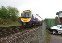 TransPennine 185121 heads west passed Chinley North Junction and signal box with a train to Manchester Airport on a wet and miserable 12 May 2013.<br><br>[John McIntyre 12/05/2013]
