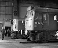 An open day at Carlisle Diesel Depot on 4th September 1976 finds BR Sulzer Type 2 No. 25304 stabled inside the shed adjacent to an unidentified class 40.<br><br>[Bill Jamieson 04/09/1976]