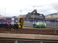 158703 stabled outside Inverness Depot on 24 June amidst much activity in the adjacent Stobart Rail facility as Tesco containers are unloaded.<br><br>[David Pesterfield 24/06/2013]