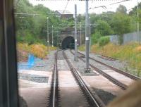 Metrolink tram driver's view of the site of Oldham Werneth station (closed 2009) from a Rochdale bound service. The tracks to Oldham Mumps through the tunnels were only temporarily electrified, as a town centre street running section was opened from the point in the foreground allowing the old railway line to close completely. [See image 21182] for the same location in 2008. <br><br>[Mark Bartlett 31/07/2013]