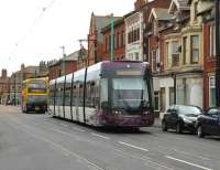 Pulling away from the penultimate northbound stop, <I>Flexity</I> 002 moves back towards the centre of North Albert St in Fleetwood town centre on 10 August and heads for Fleetwood Ferry, closely followed by a Blackpool bus. <br><br>[Mark Bartlett 10/08/2013]