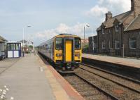A pair of Class 153 single units calling at Bootle on a service from Barrow to Carlisle on 27 July. The station building is a private residence now but the signal box and its semaphores still control the block section and protect the level crossing.<br><br>[Mark Bartlett 27/07/2013]