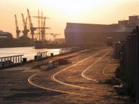 The cranes of the Govan shipyards are silhouetted by the evening sun on 7 May 2013. View west from Yorkhill Quay with Glasgow's Riverside Museum in the right background.<br><br>[Colin Harkins 07/05/2013]