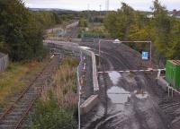 View south from the B6415 bridgeat Millerhill village over the course of the Waverley Route and the Glencorse branch (latterly serving Bilston Glen Colliery). Cutting across the trackbed is a new access route to a Borders Railway construction site. The signal seems a bit redundant...Taken at dusk on 21 September 2013. [See image 37199]<br><br>[Bill Roberton 21/09/2013]
