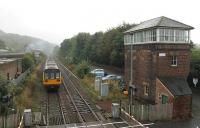 Pulling away from a stop at Prudhoe on 4 October, Northern 142092 passes the tall signalbox as it heads west along the Tyne Valley towards Hexham. <br><br>[Mark Bartlett 04/10/2013]
