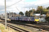 Crossing from the Barrow line platform to the Up Main line as it leaves Carnforth is Northern 150145. The train is the daily Leeds to Heysham Port service, which will reverse at Lancaster and Morecambe before connecting with the Douglas sailing. <br><br>[Mark Bartlett 25/10/2013]