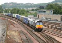 DRS 66408 crosses over to the Dundee line on the southern approach to Perth station in June 2006 with a train of containers from WHM Grangemouth destined for Aberdeen.<br><br>[John Furnevel 15/06/2006]