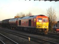 DB liveried 60040 pulls out of the down loop at the east end of Swindon Station on 4 December with the Theale to Robeston empty fuel tanks.<br><br>[David Pesterfield 04/12/2013]